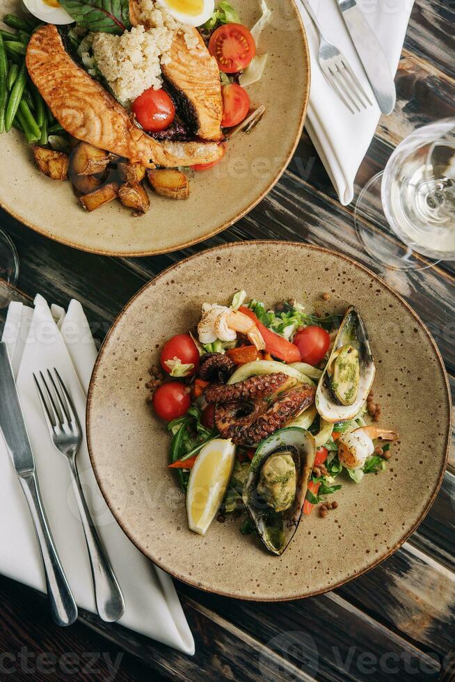 Top view seafood dishes on wooden table photo