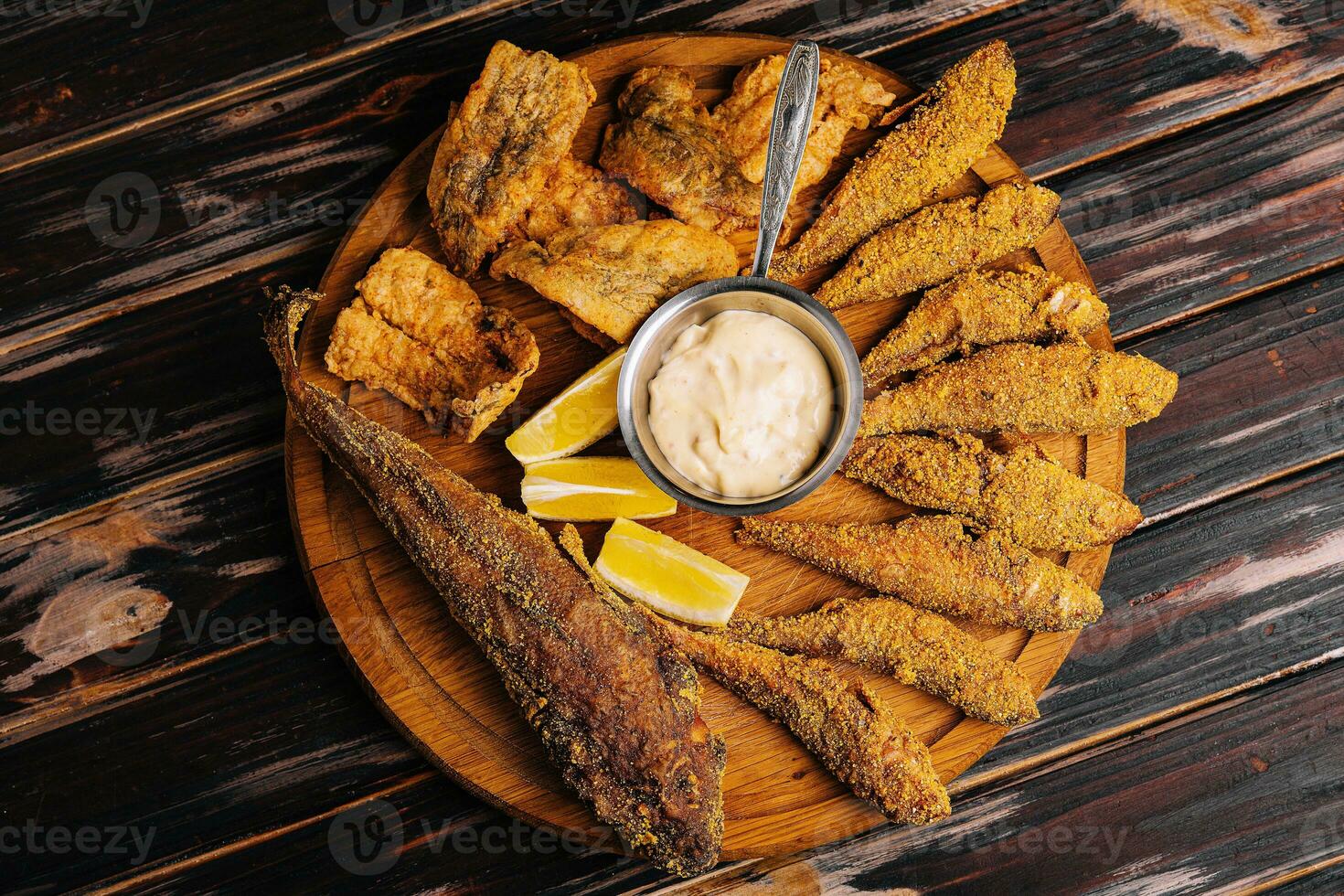fried red mullet fish on wooden board photo