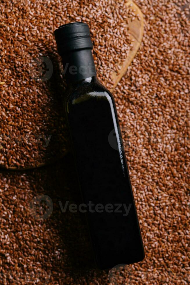 linseed oil bottle with linseed background photo