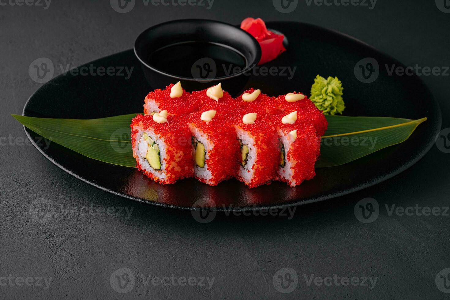 California Sushi roll cutting on black plate photo