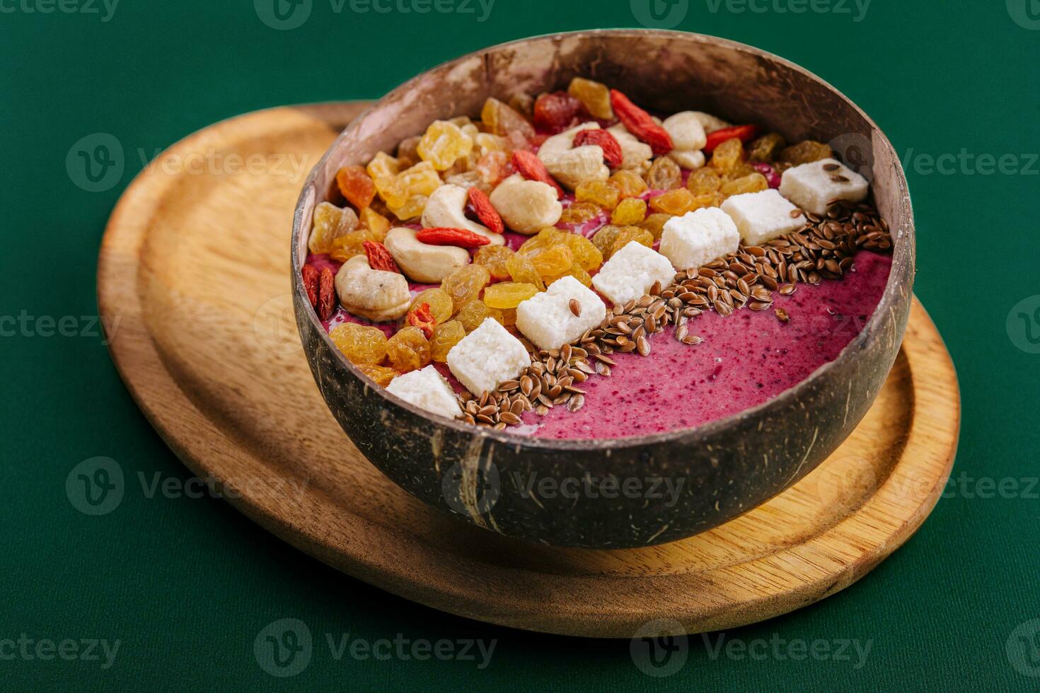 Healthy breakfast raisins and cashew nuts smoothie in coconut bowl photo