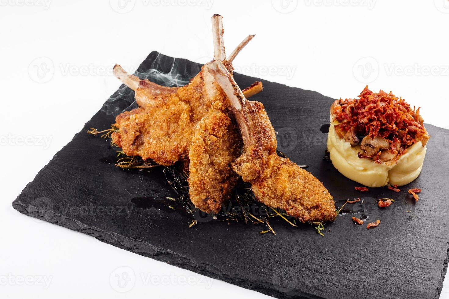 Roasted pork ribs, garnished with onion chips and mashed potatoes photo