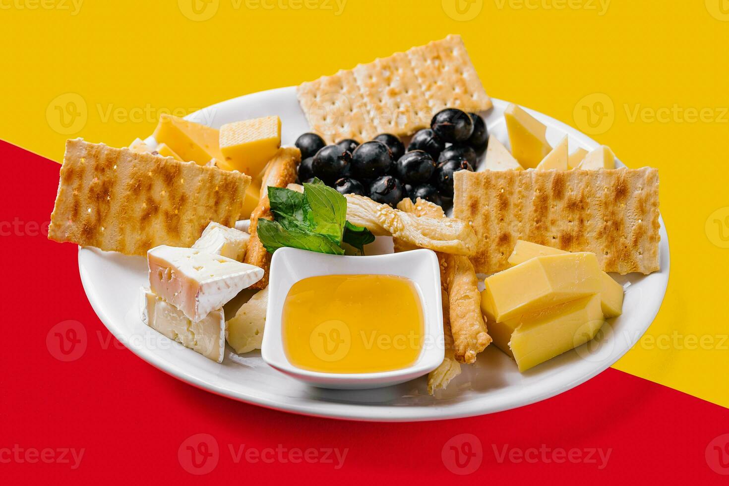 Different types of cheese on a white plate photo