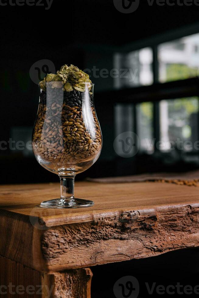 Hops and wheat in a glass for beer photo