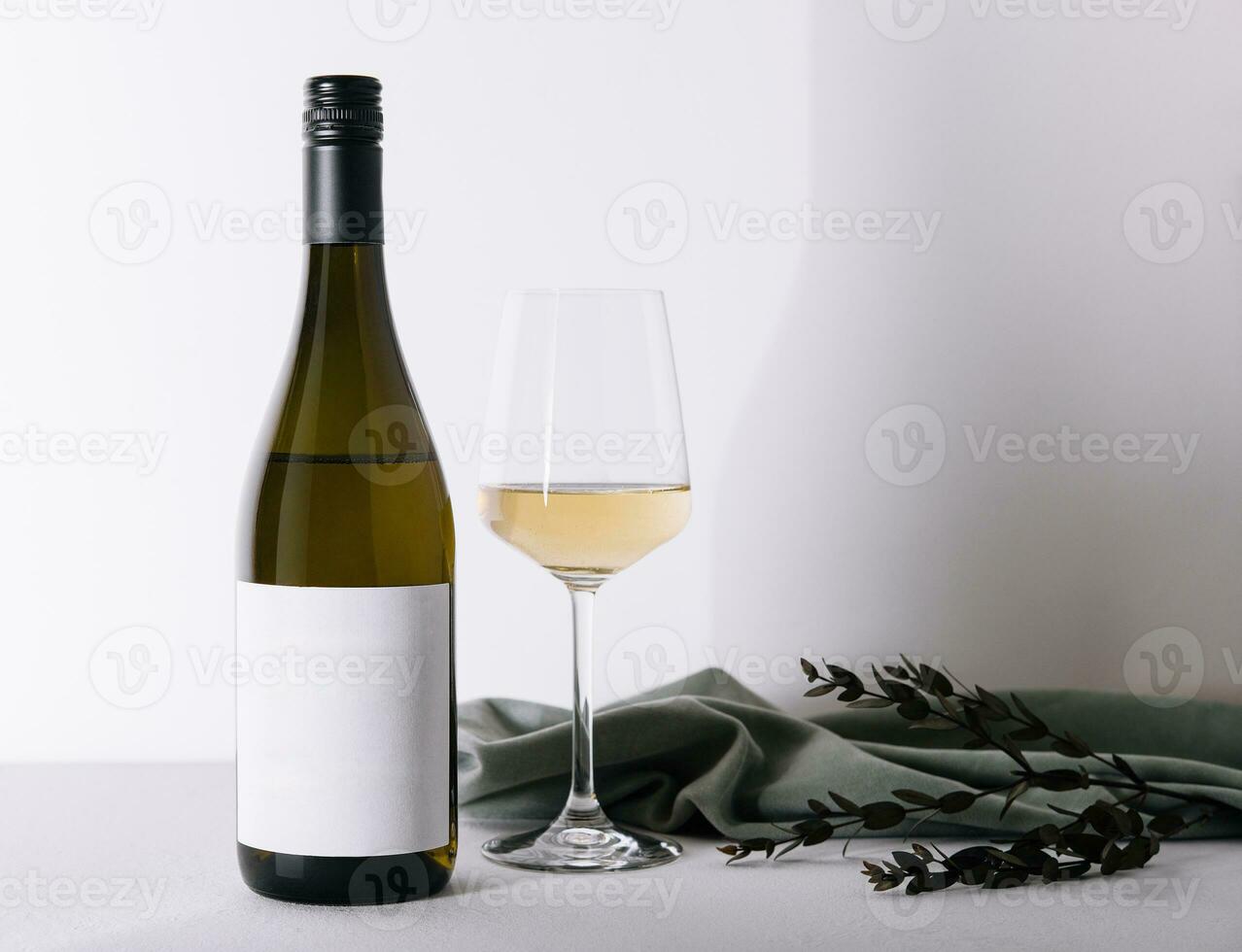 Bottle and glass of white wine isolated on white background photo