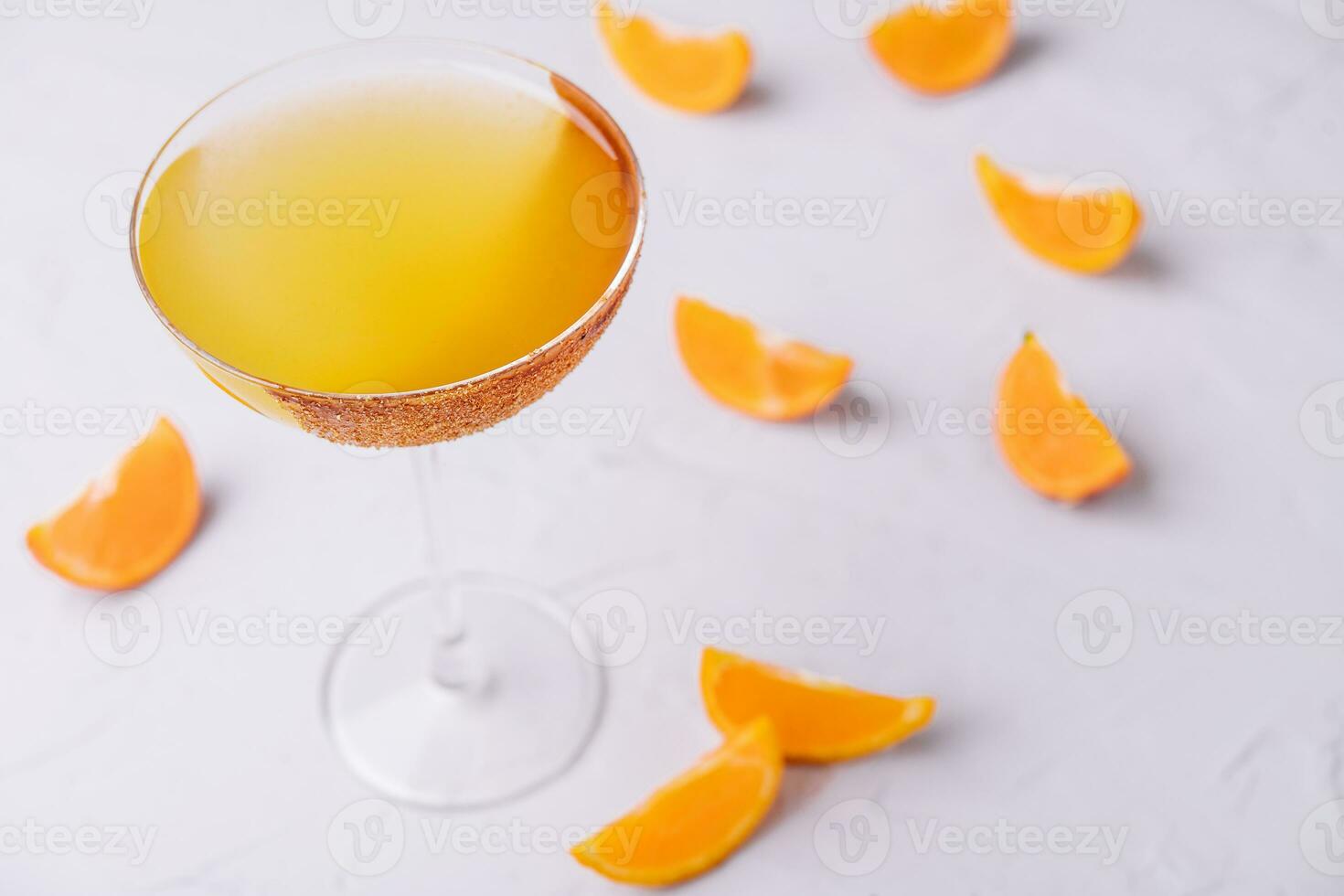 Glass of sidecar orange cocktail top view photo