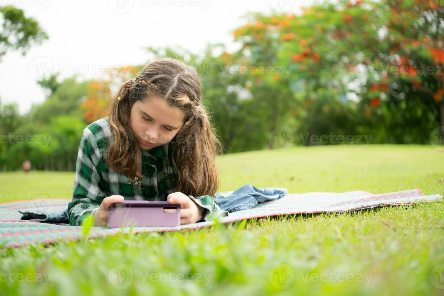 On a beautiful day in the park, a little girl enjoys her vacation. photo