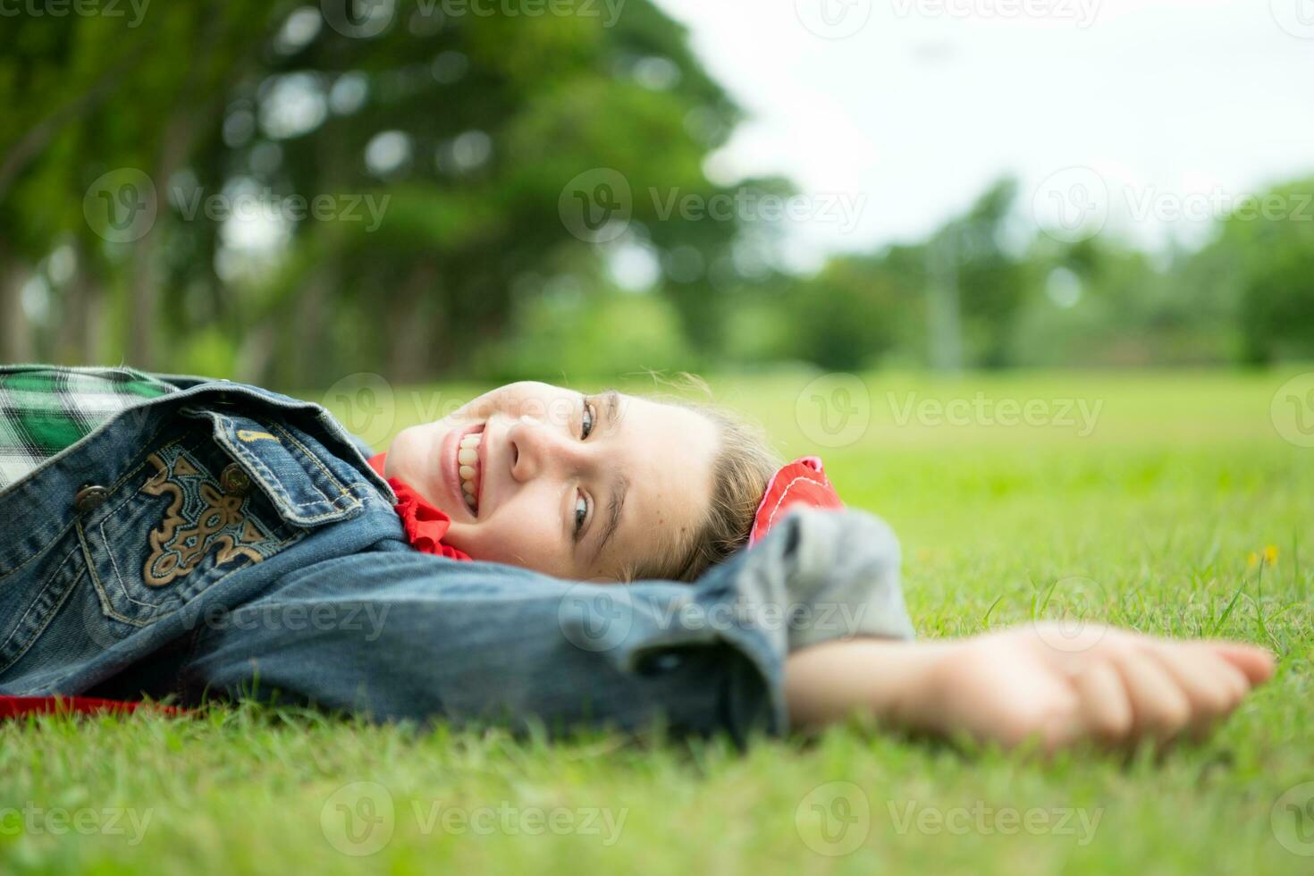 On a beautiful day in the park, a little girl enjoys her vacation. photo