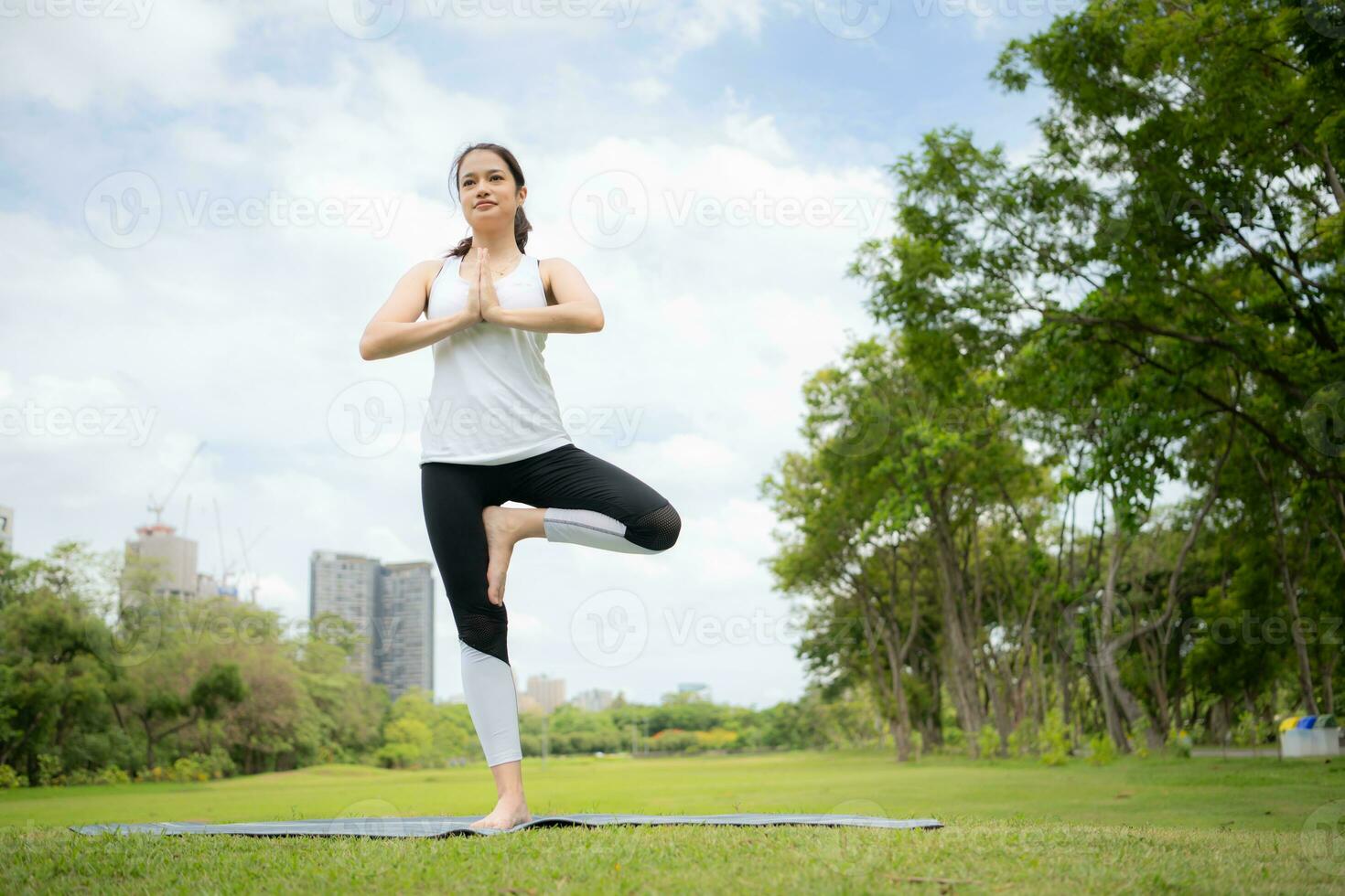 Young female with outdoor activities in the city park, Yoga is her chosen activity. photo