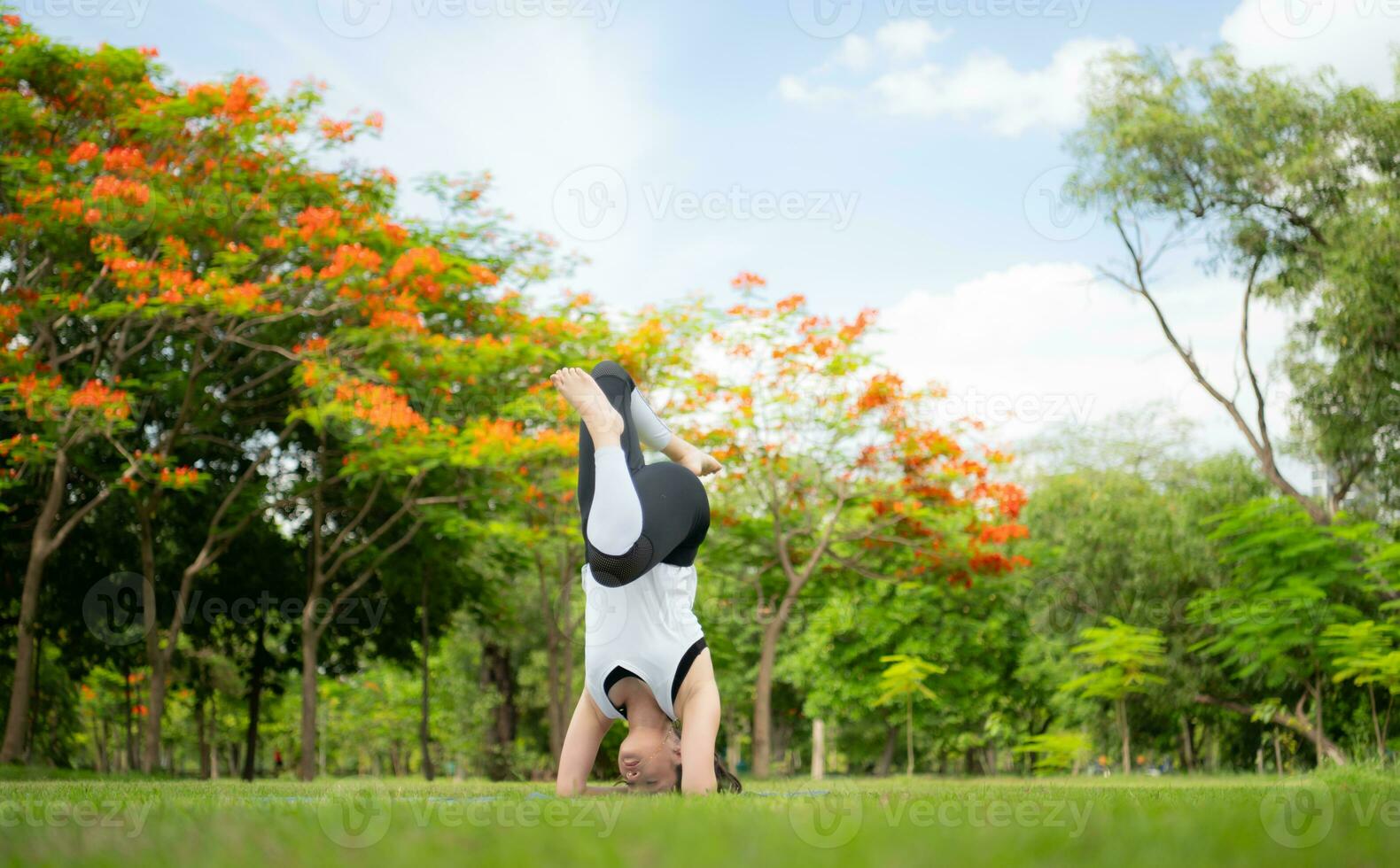Young female with outdoor activities in the city park, Yoga is her chosen activity. photo