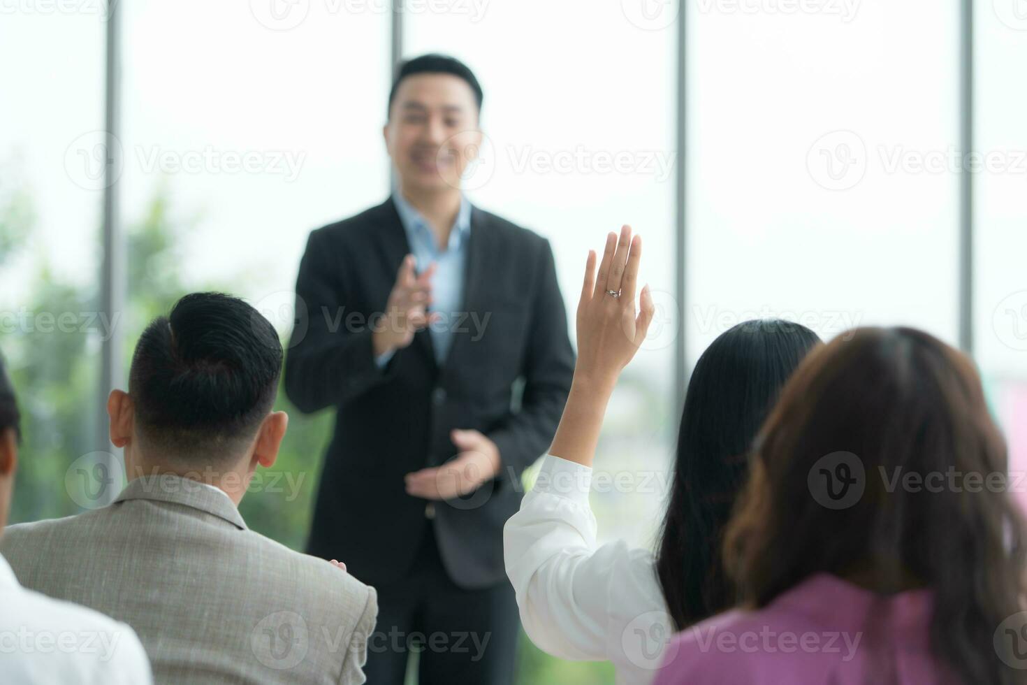 A group of business people organizes a seminar. Discuss the success of doing business in a technology-driven era. photo