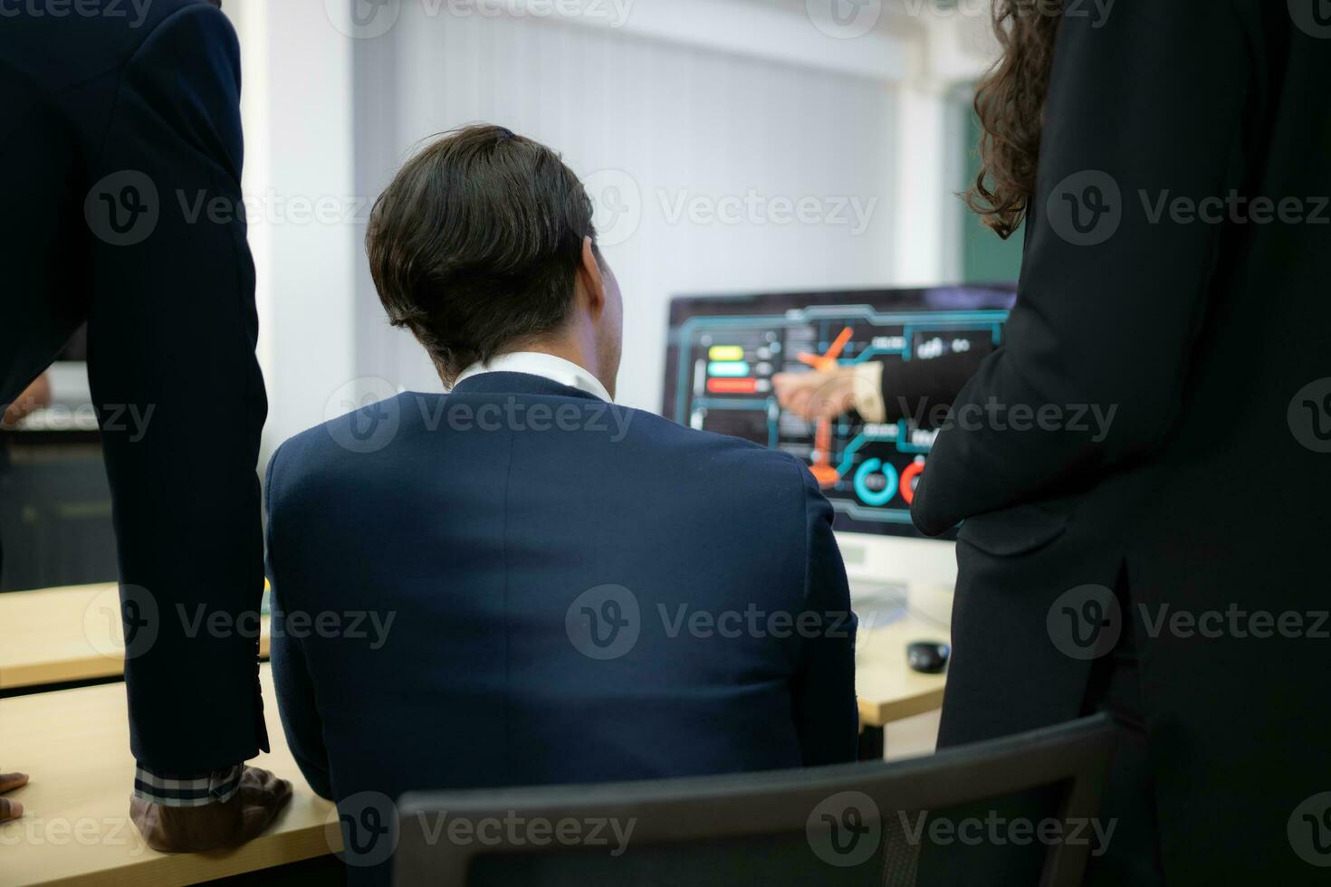 Diverse team of businessmen and engineers consultation on the engineering of a wind turbine that converts wind energy to electricity in the office. photo