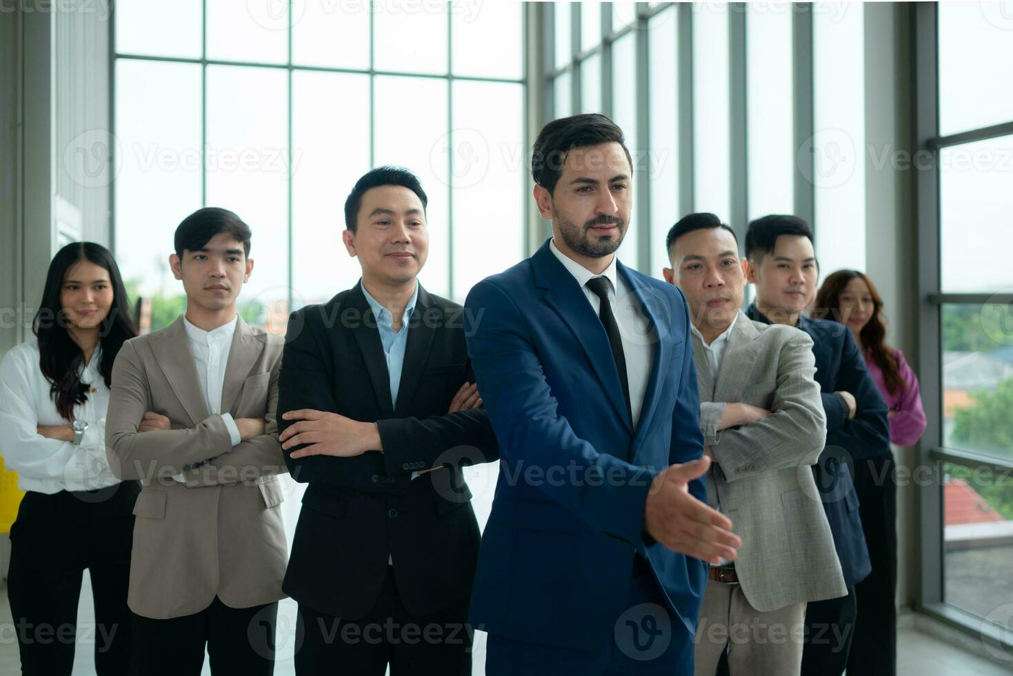 Group of business people standing in line in conference room used for meeting in modern office photo