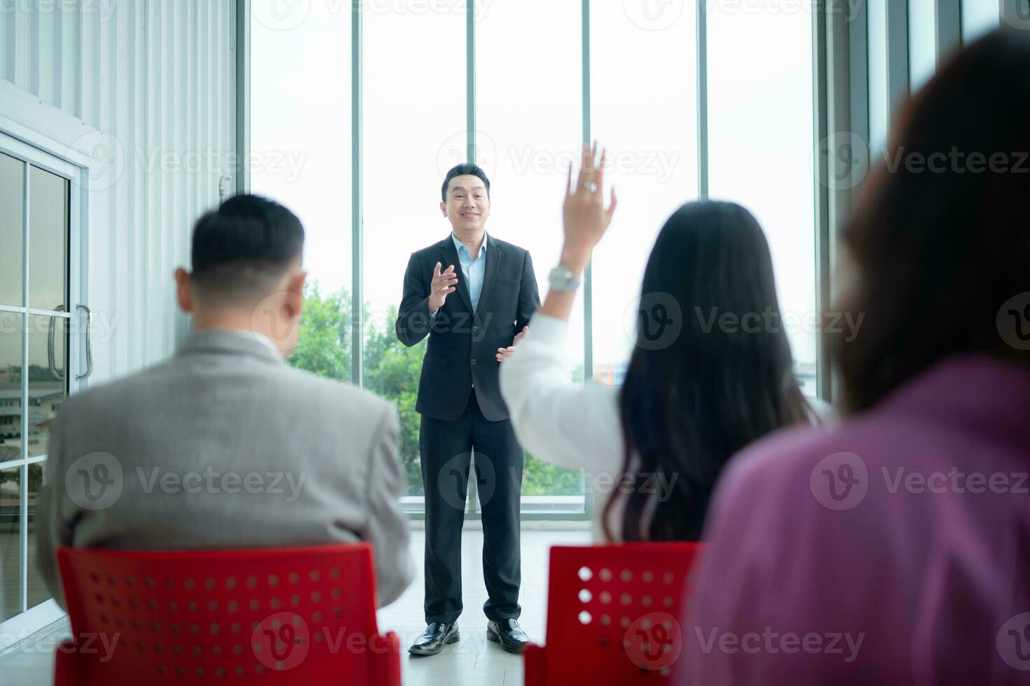 A group of business people organizes a seminar. Discuss the success of doing business in a technology-driven era. photo