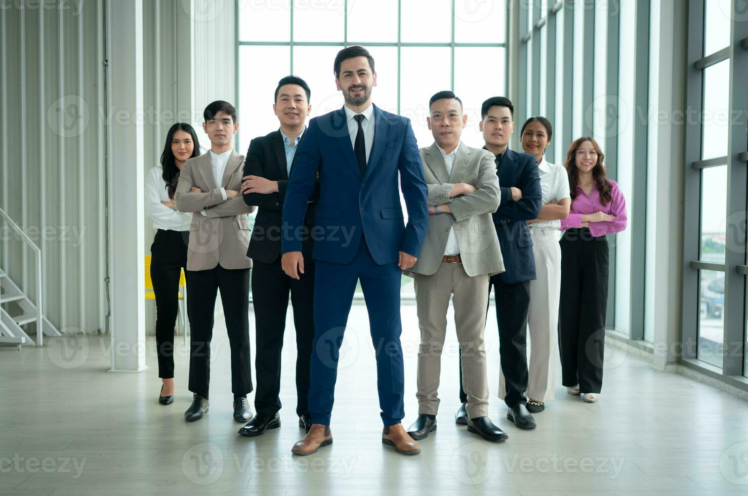 Group of business people standing in line in conference room used for meeting in modern office photo