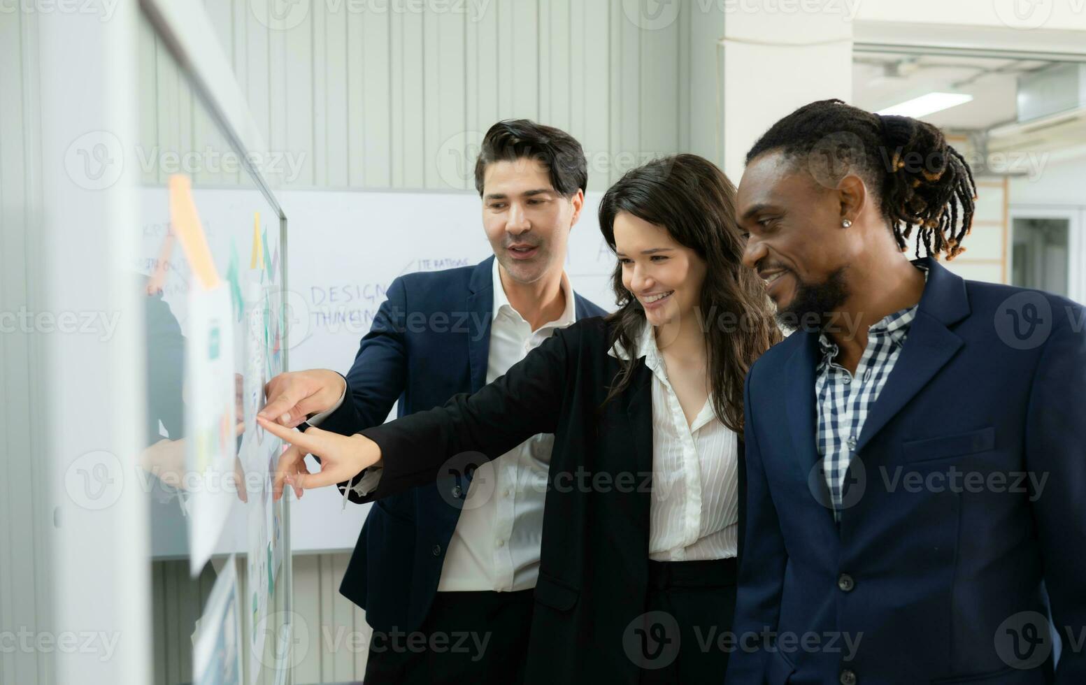 Group of business people discussing the charts and graphs showing the results of their successful teamwork photo