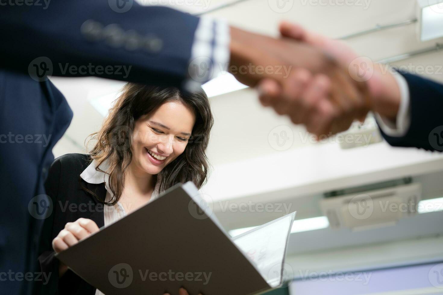 Business people shaking hands, finishing up a meeting. Shallow depth of field. photo