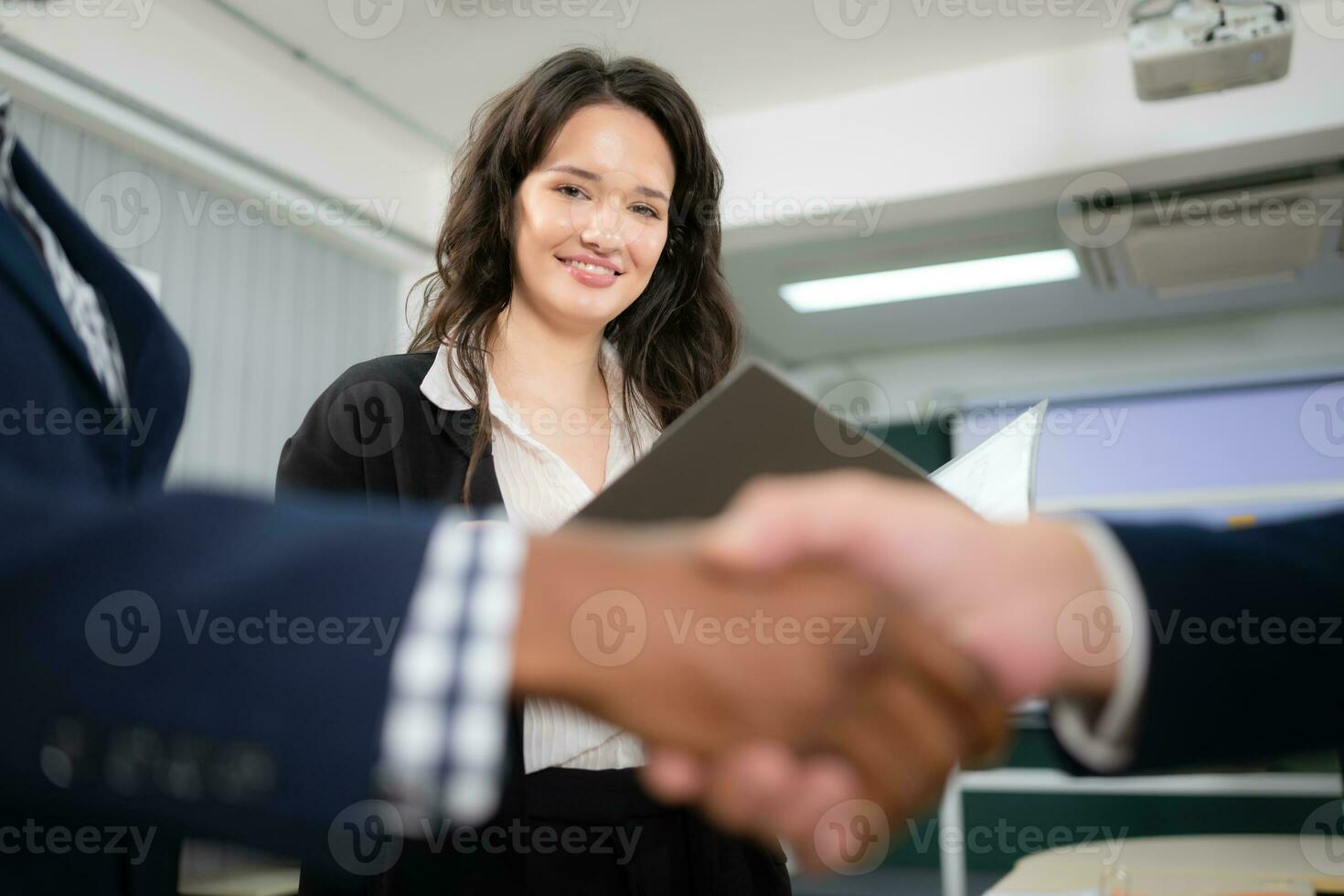 Business people shaking hands, finishing up a meeting. Shallow depth of field. photo