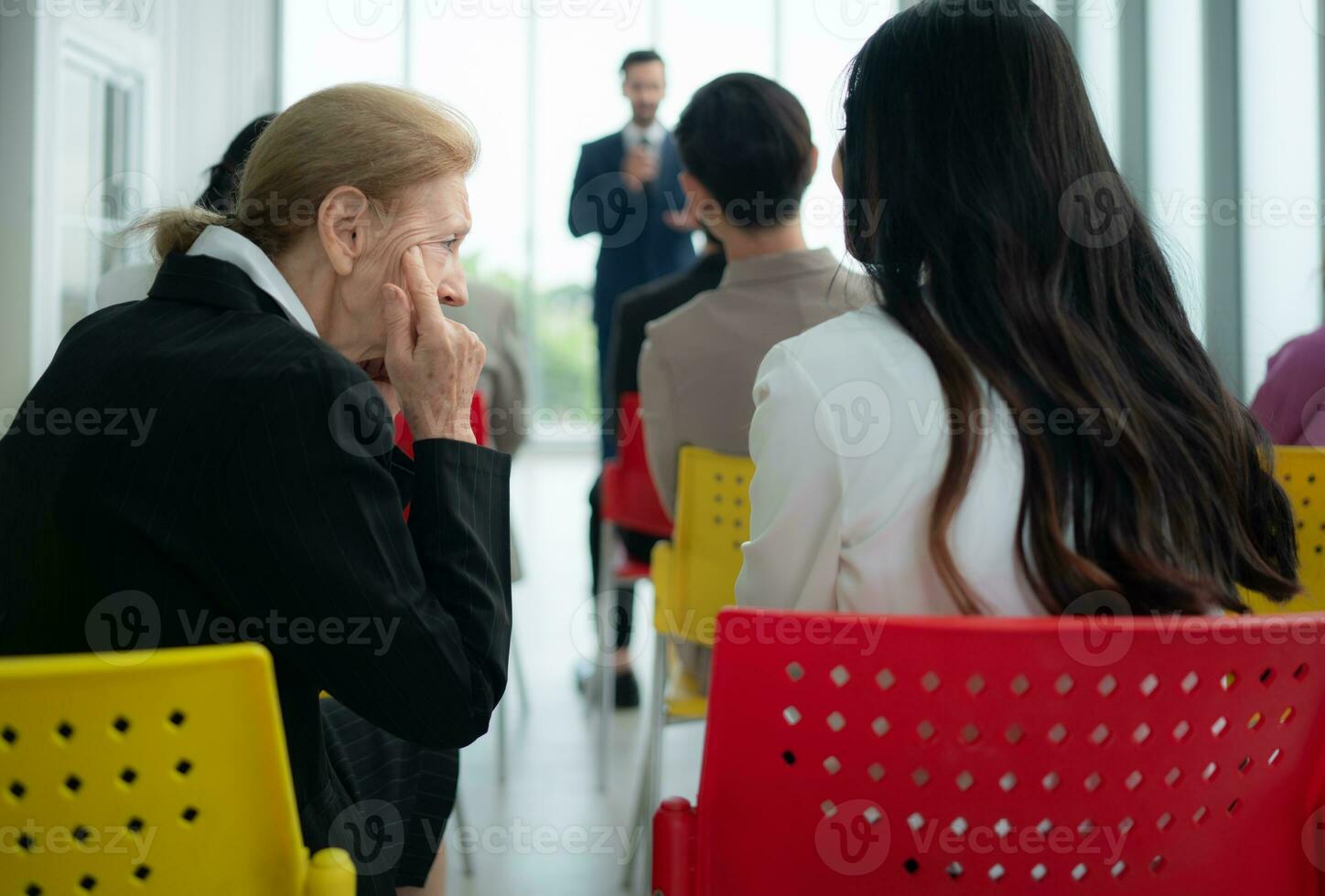 A group of business people organizes a seminar. Discuss the success of doing business in a technology-driven era. photo