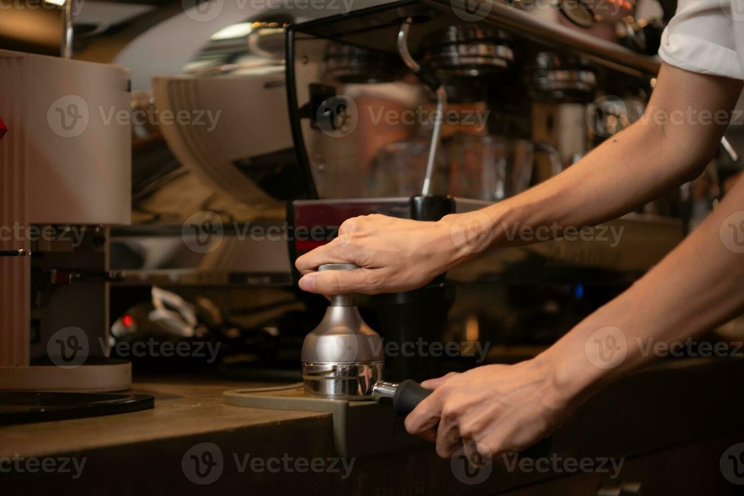 Close-up of barista hands using Portafilter for making espresso. photo