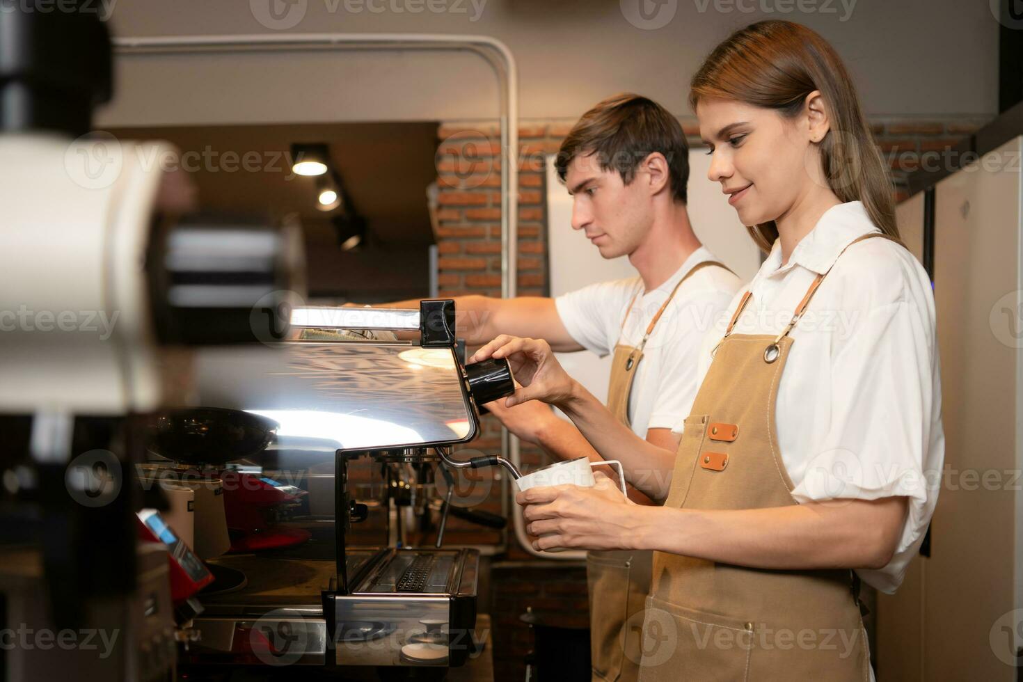 Barista pouring coffee into a cup in coffee shop, closeup photo