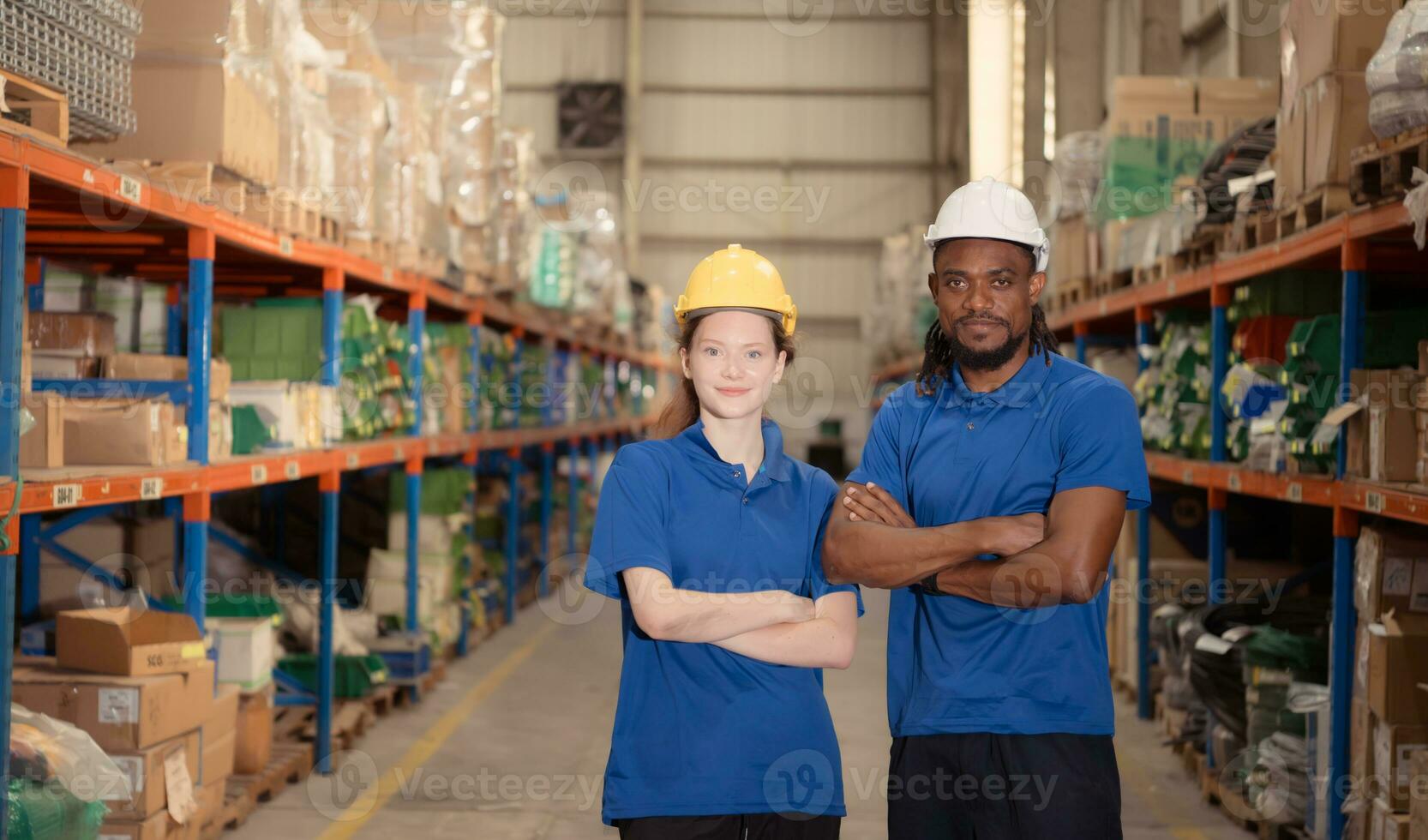 Portrait of confident warehouse staff standing with arms crossed in a warehouse photo