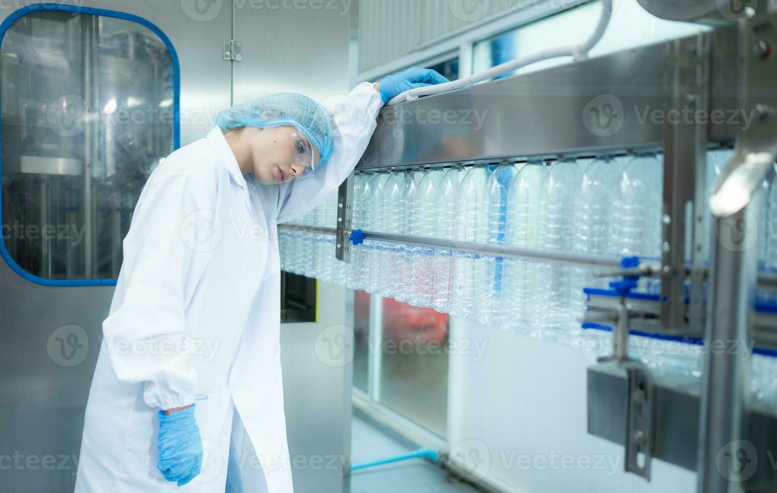 Fatigue female scientist working in a lab checking drinking water quality photo
