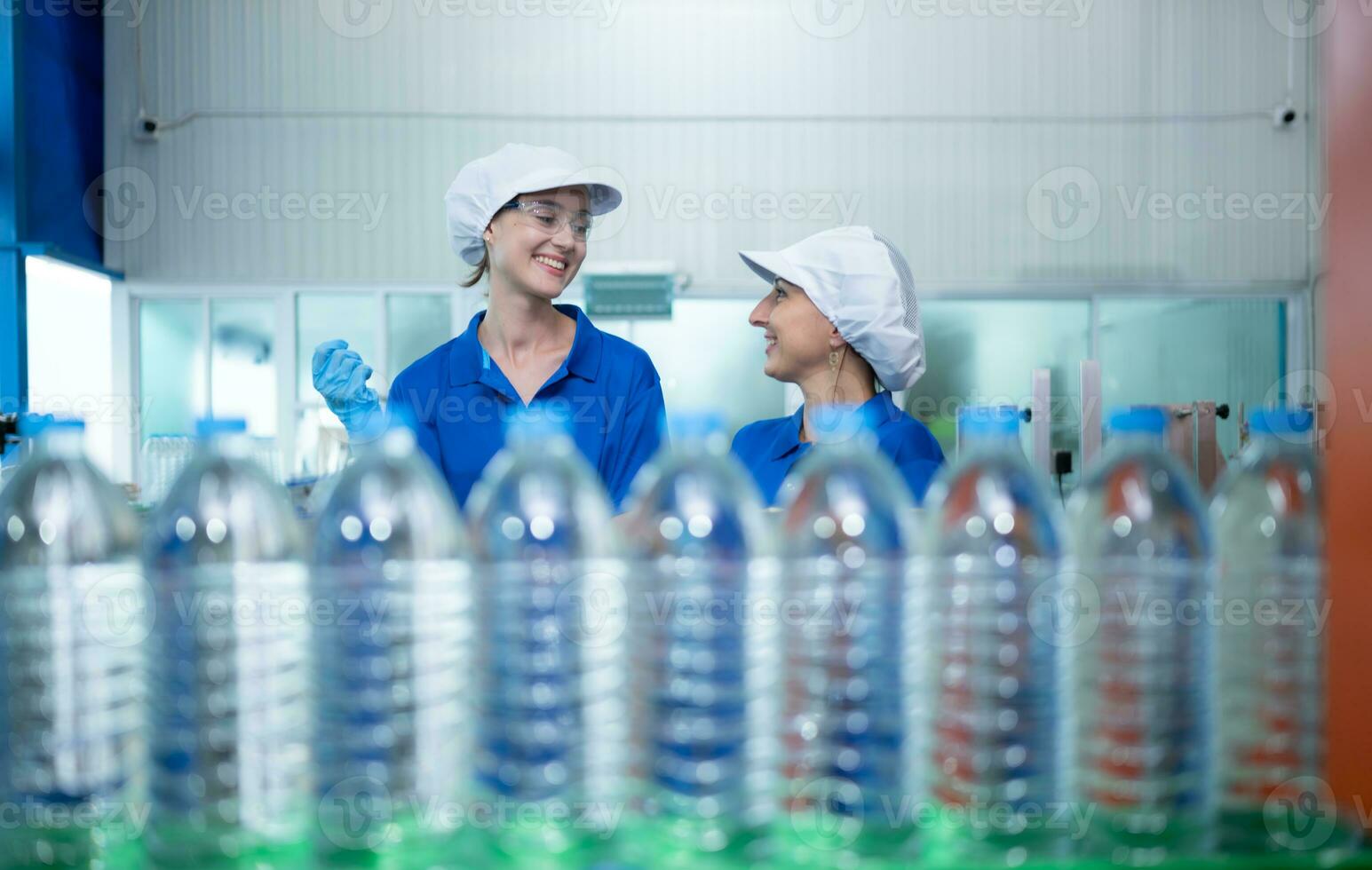 Drinking water factory worker at a production line of drinking water