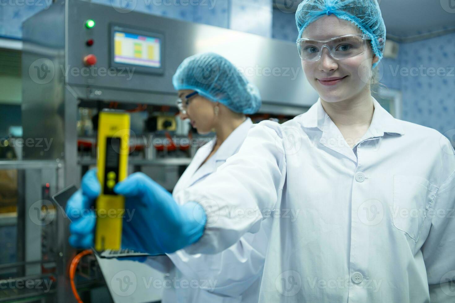 Portrait of confident female researcher carrying out scientific experiment in drink water laboratory photo