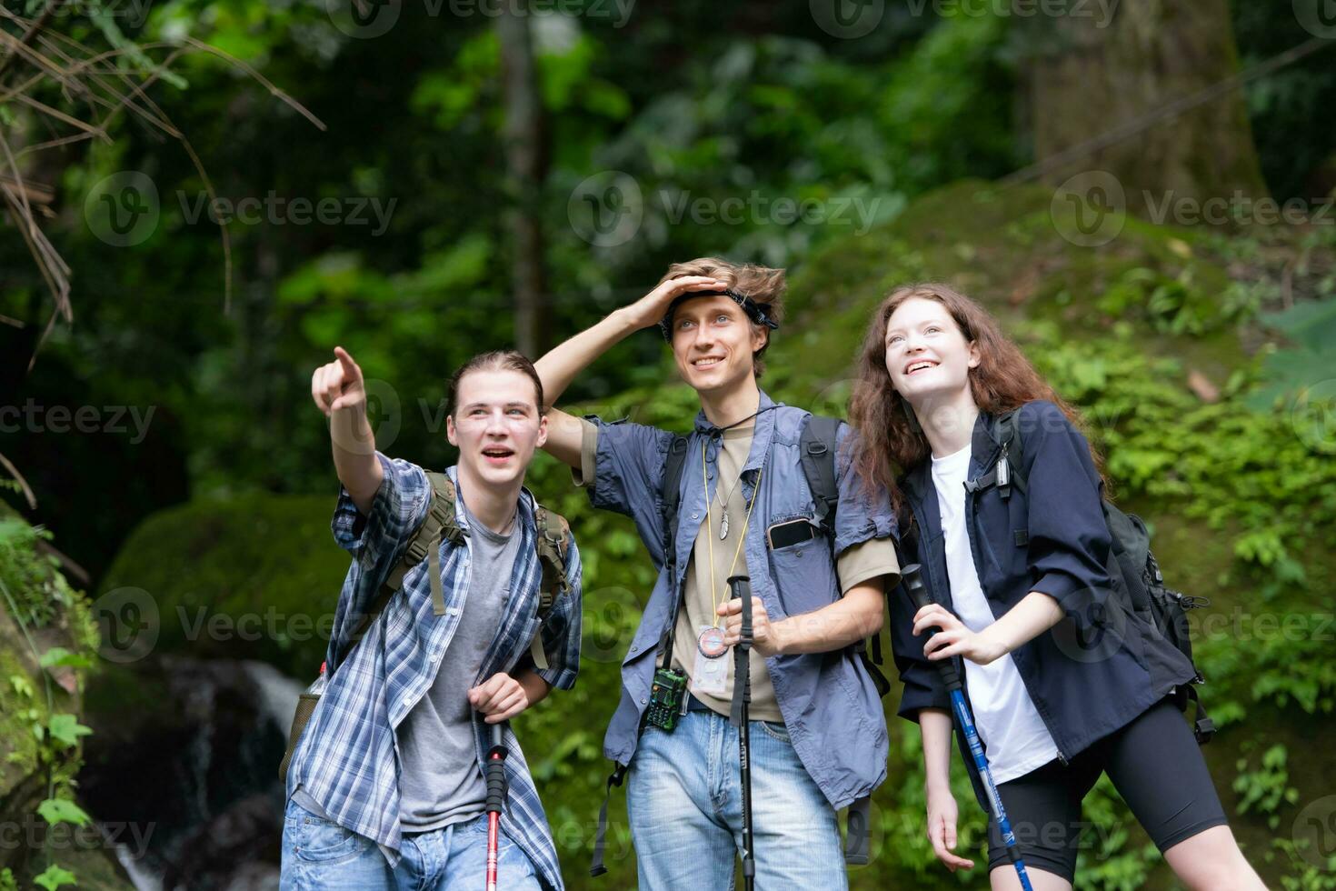 Group of young people hiking in the forest. Travel and adventure concept. photo