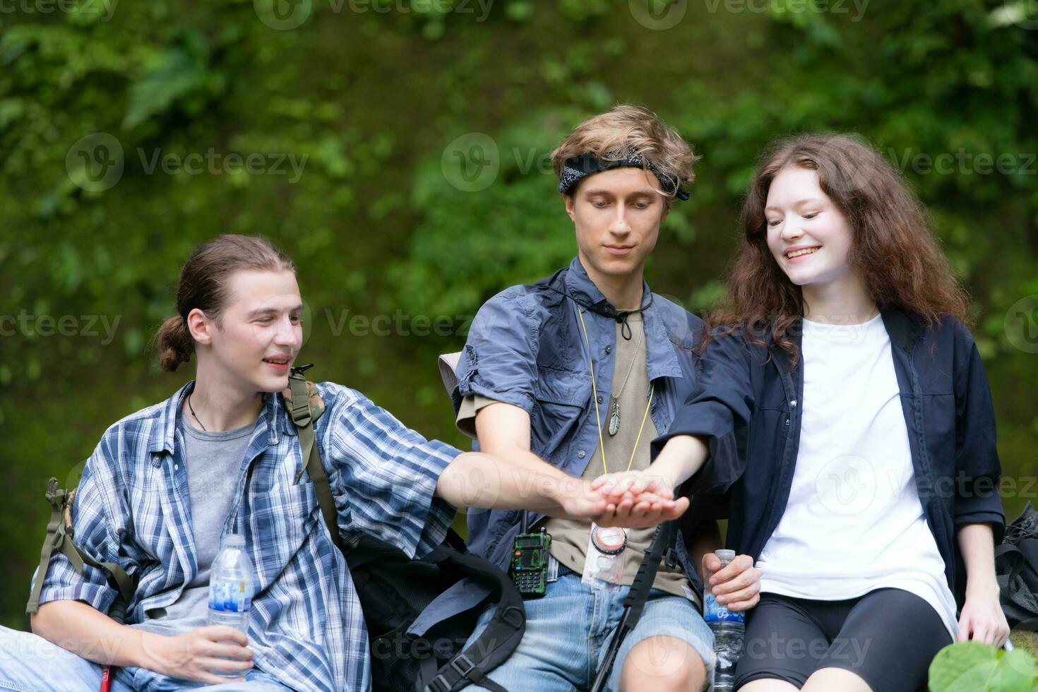 Group of young people hiking in the forest. Travel and adventure concept. photo