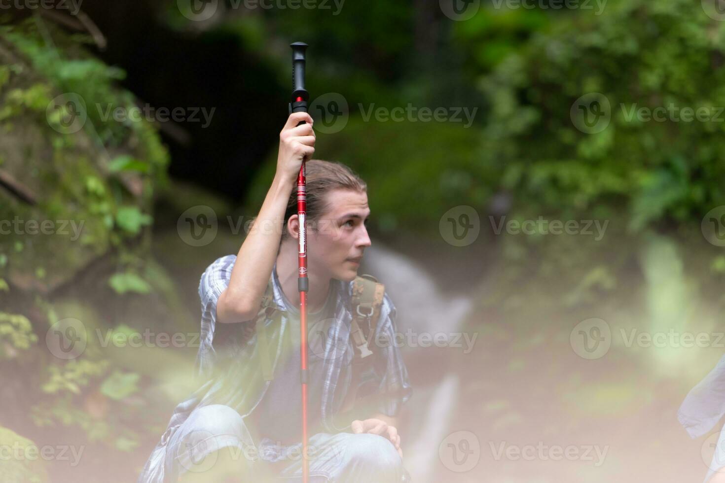 Group of young people hiking in the forest. Travel and adventure concept. photo