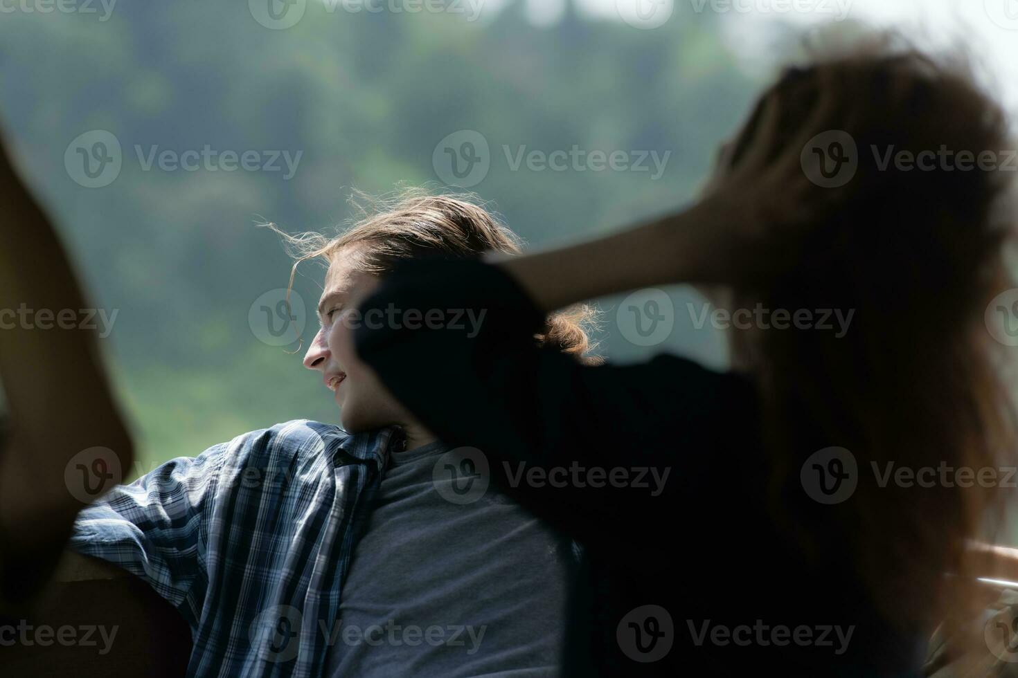 A young couple sits on a boat for a journey into the forest above the dam for trekking. photo