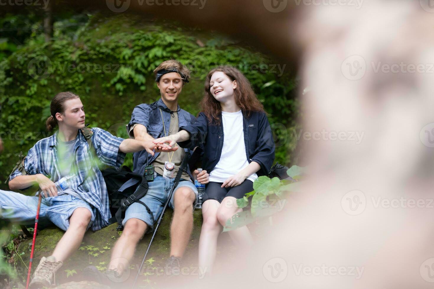 Group of young people hiking in the forest. Travel and adventure concept. photo