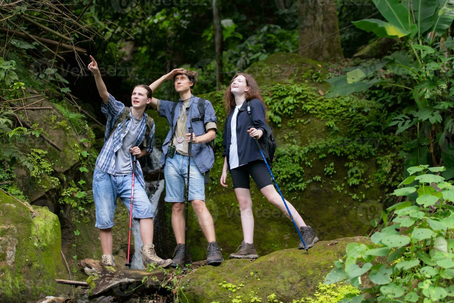 Group of young people hiking in the forest. Travel and adventure concept. photo