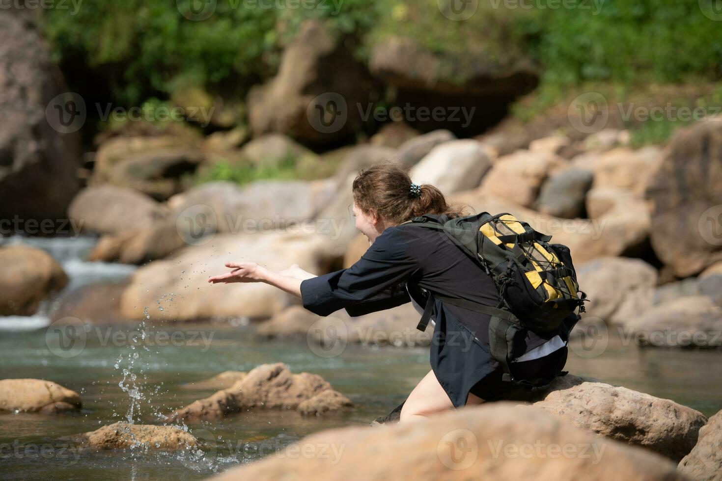 Young woman with backpack hiking in the forest. Active lifestyle concept. photo