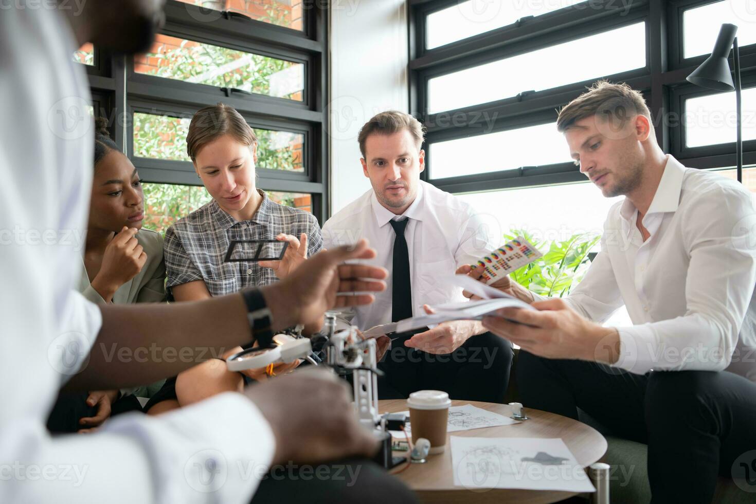 Group of diverse business people working together in the office, Brainstorming about the hand robot model to be used for production work photo