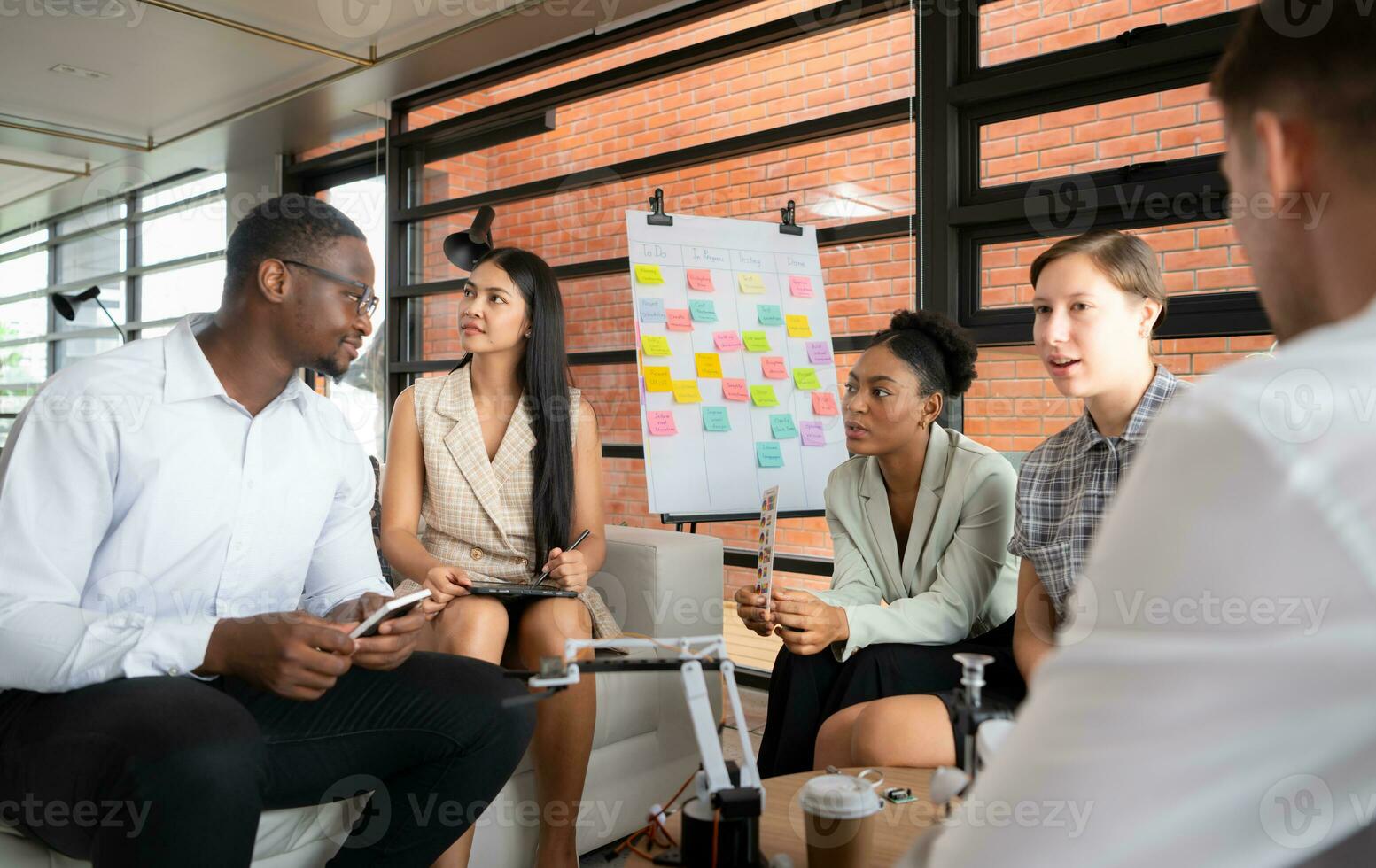 Group of diverse business people working together in the office, Brainstorming about the hand robot model to be used for production work photo