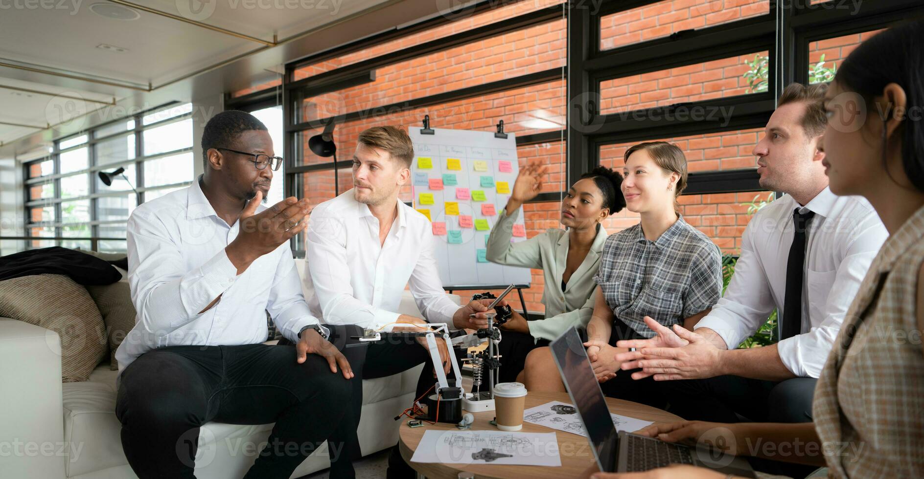 Group of diverse business people working together in the office, Brainstorming about the hand robot model to be used for production work photo