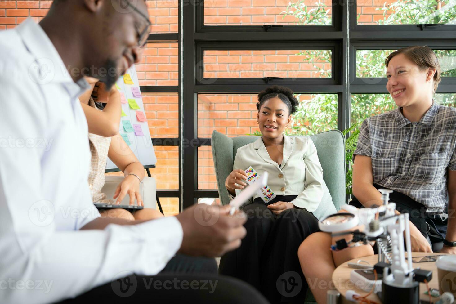 Group of diverse business people working together in the office, Brainstorming about the hand robot model to be used for production work photo