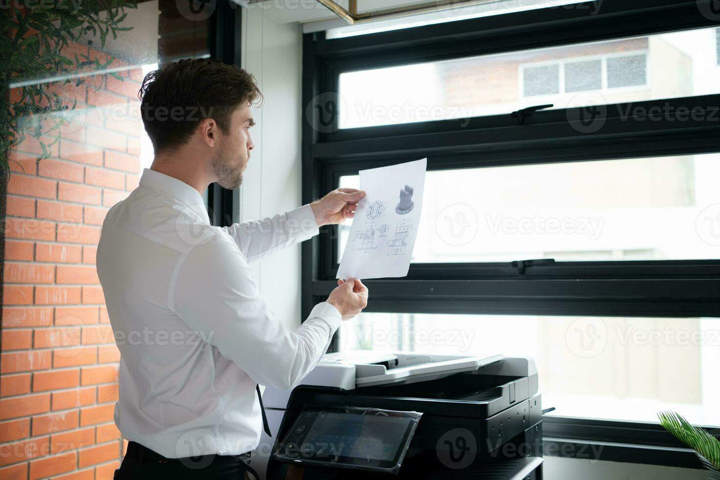 Businessman in office working with copier. photo
