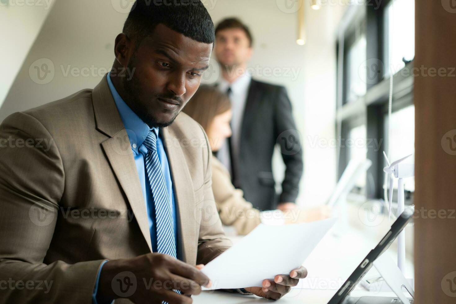 Young businessman and diverse group of business people working together in office, Brainstorming on how to use natural energy from wind and sunlight to offer customers. photo