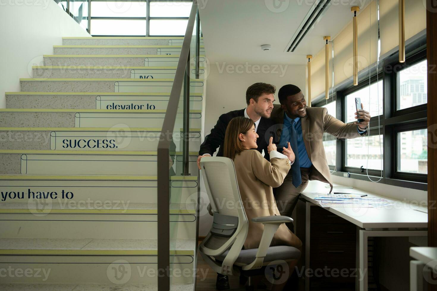 Group of business people discussing business plan at meeting in modern office. Businessman and businesswoman using mobile phone to take a selfie. photo