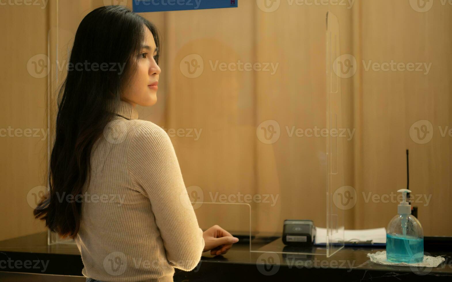 Young woman in front of the box office booking movie tickets photo