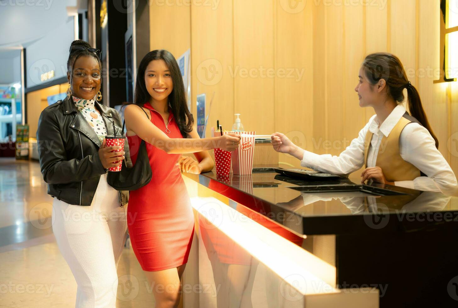 Asian ticket seller at the box office with the service of selling movie tickets to movie audiences in each round photo