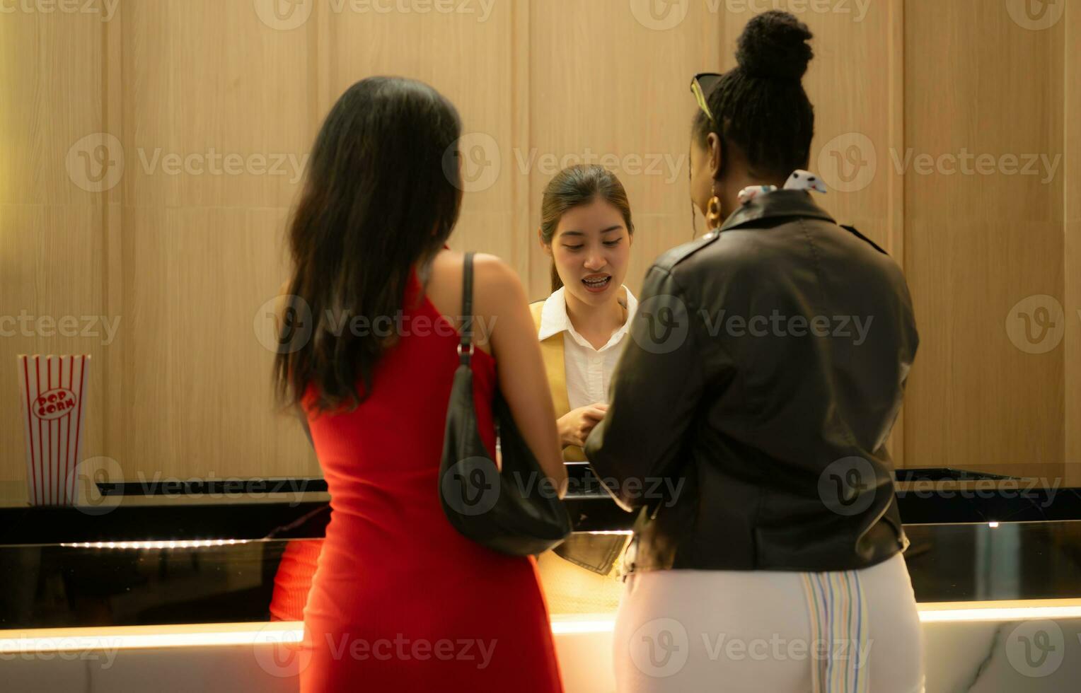 Close-up of a couple holding hands in a box office waiting to buy movie tickets photo