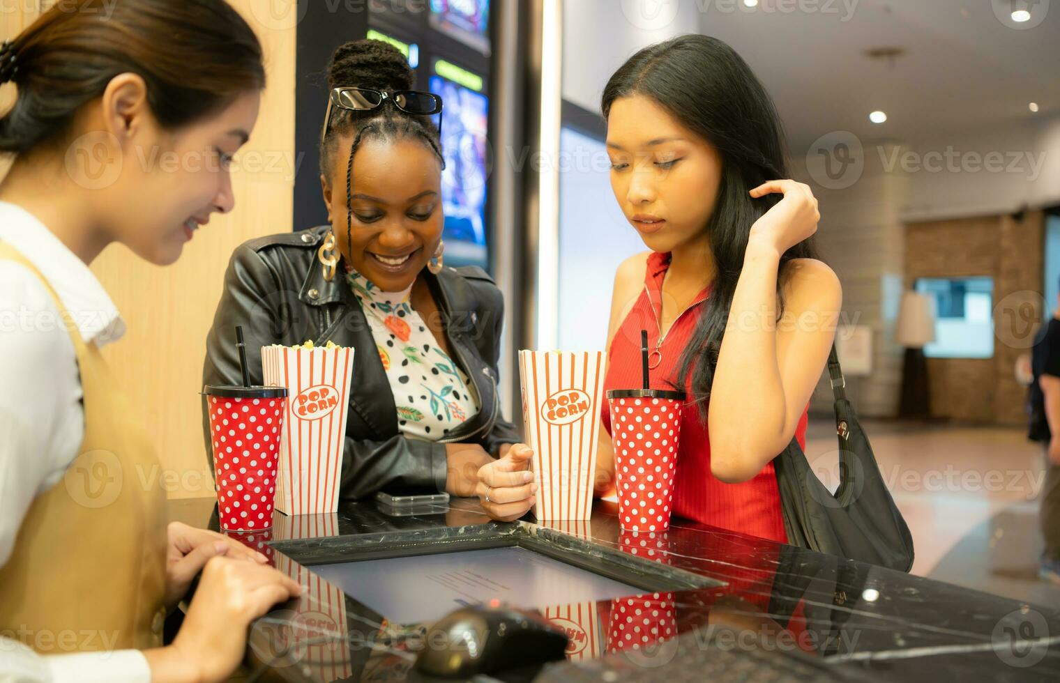 Asian ticket seller at the box office with the service of selling movie tickets to movie audiences in each round photo