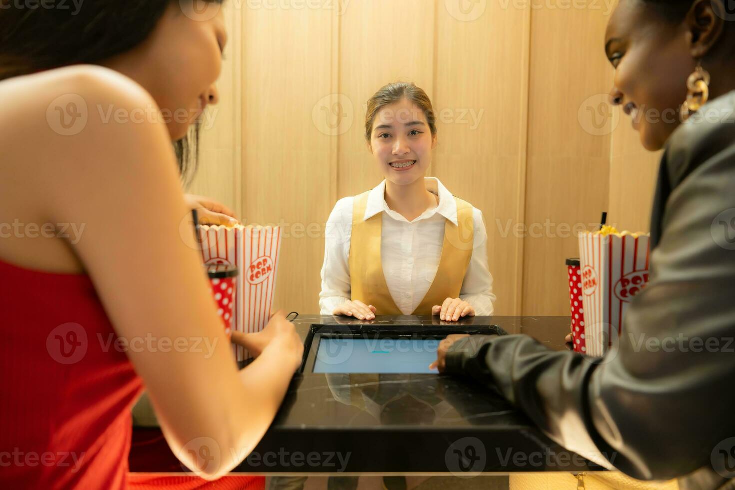 Asian ticket seller at the box office with the service of selling movie tickets to movie audiences in each round photo