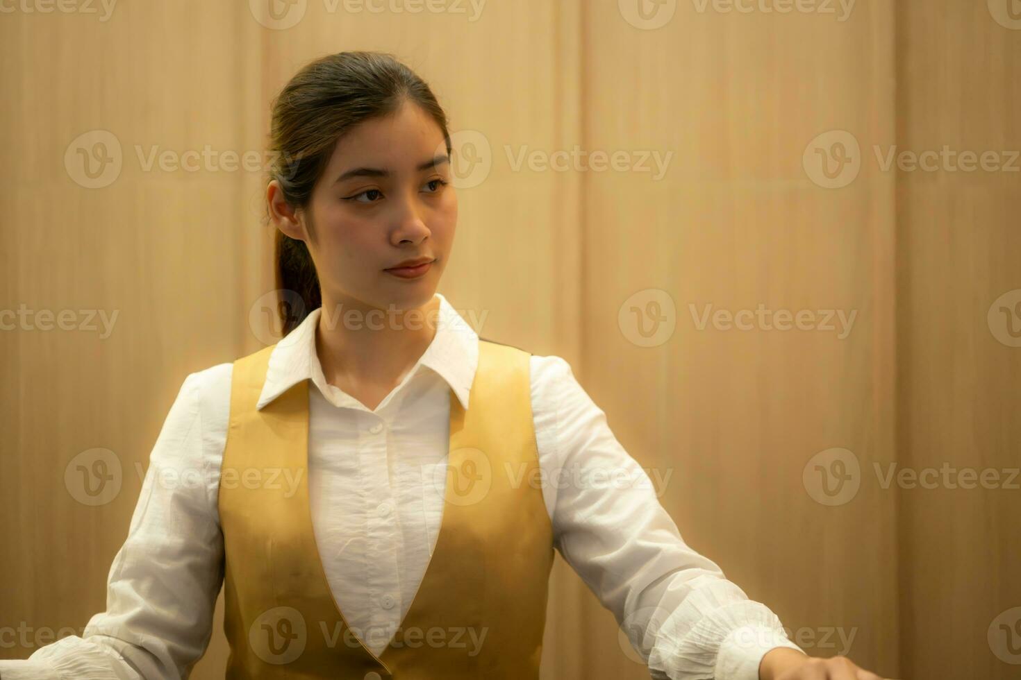 Asian ticket seller at the box office with the service of selling movie tickets to movie audiences in each round photo