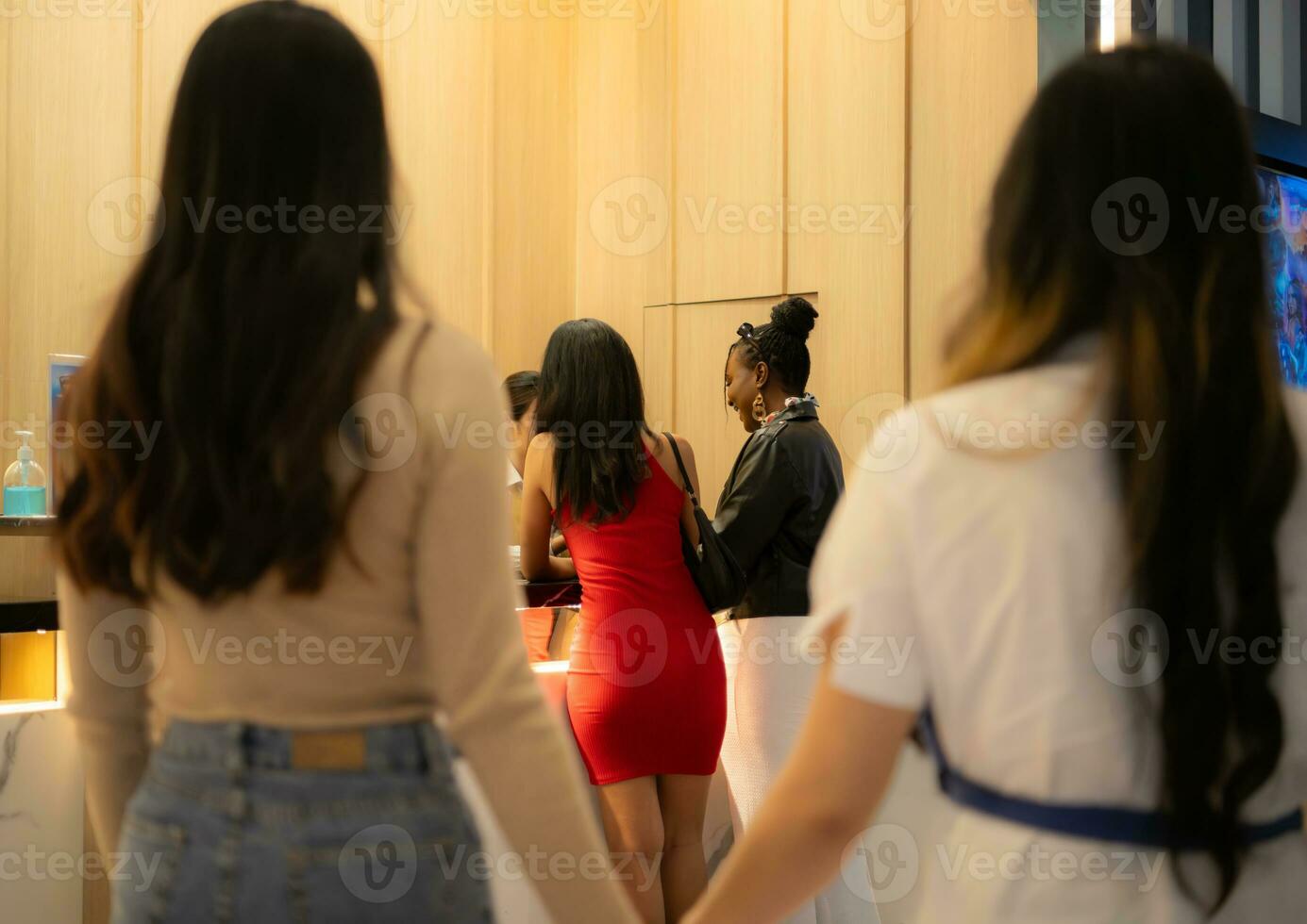 Close-up of a couple holding hands in a box office waiting to buy movie tickets photo